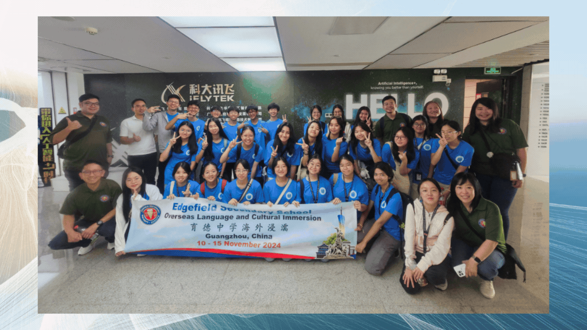 A large student group in blue shirts holds a banner for Edgefield Secondary School cultural immersion in Guangzhou, China, November 2024.